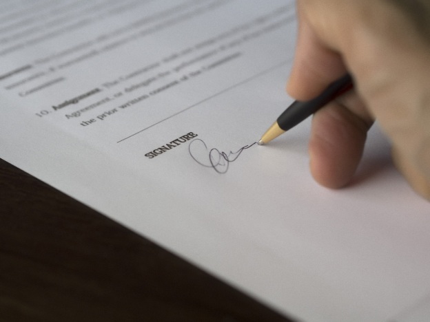 A borrower signing a loan workout agreement made by a private money lender