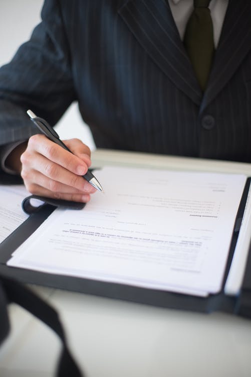 A businessperson signing a document