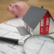 A house model and a magnifying glass