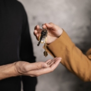 A person handing a house key to another person