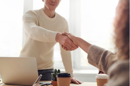 A person shaking hands with a lender