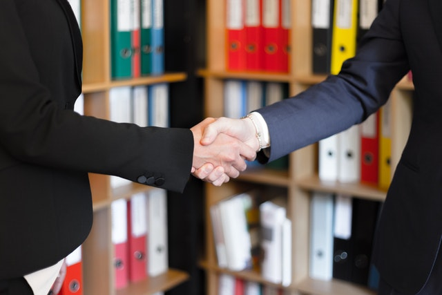 A private hard money lender shaking hands with a client