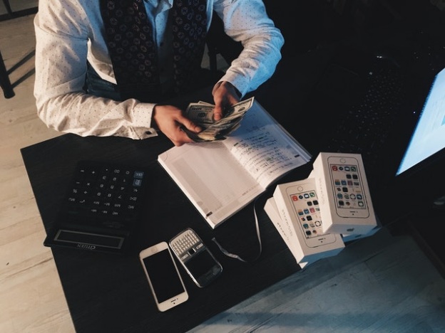 A private money lender calculating a loan workout agreement