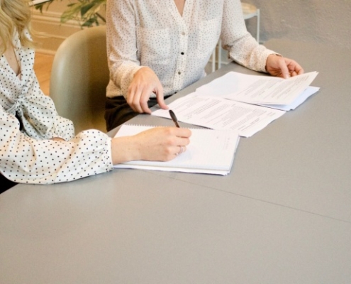 Two women negotiating the terms of the contract