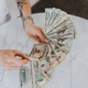 a person holding dollar bills